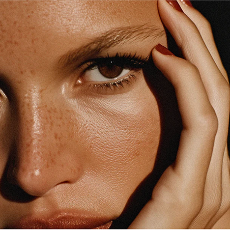 Close-up portrait showing naturally textured, glowing skin
